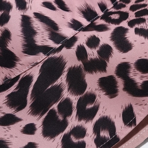 Detailed close-up of pink leopard print fabric and fine stitching on a sun hat