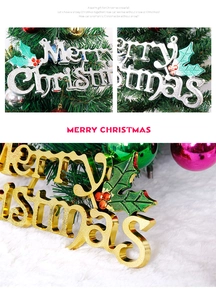 Detailed view of silver and gold Merry Christmas lettering with festive holly leaves