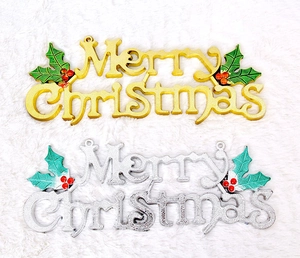 Detail view of gold and silver Merry Christmas signs with holly leaves for wreaths
