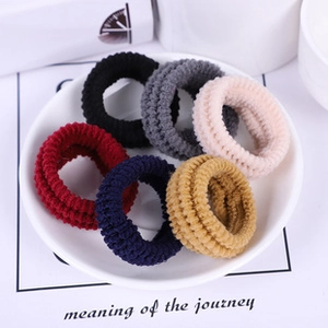 Close-up of high elasticity ribbed nylon hair ties in six different neutral colors