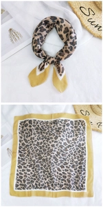 Detailed view of leopard print cotton silk scarf with yellow borders in flat and tied styles
