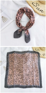Detail of leopard print cotton linen small square scarf with dark grey trim and knots