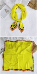 Detail of yellow silk scarf with orange plaid borders and fashion cartoon illustration