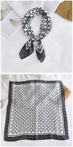 Detail of a square silk scarf with black and white geometric link patterns and border