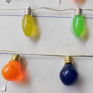 Close-up of multicolored festive plastic bulbs with metallic caps for holiday decoration