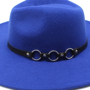 Detail of royal blue wool fedora hat with black leather band and silver metal rings