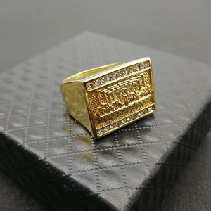 Macro shot of gold-plated square ring featuring The Last Supper relief and white zircons