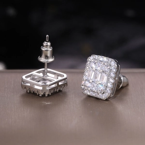 Macro detail of silver-tone square zircon earrings with brilliant halo setting and backings