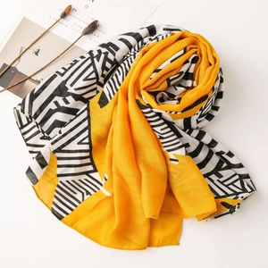 Macro detail of breathable yellow and geometric print scarf with smooth rolled edges