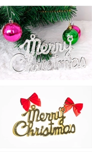 Detail of gold and silver Merry Christmas sign pendants with festive red bow decorations