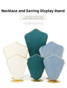 Detail of velvet jewelry stand with gold metal trim for necklaces and earrings
