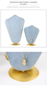 Detail of light blue velvet necklace stands with elegant gold circular metal bases