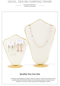 Detailed view of golden jewelry display stand set with white velvet for necklaces and earrings