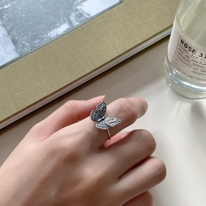 Detail shot of vintage silver butterfly open ring showing intricate wing textures