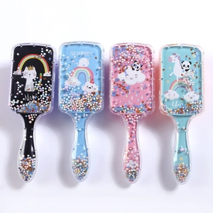 Detailed view of kids air cushion hair brushes with colorful liquid glitter and unicorn prints