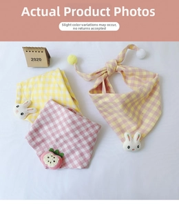 Detail view of cotton plaid triangle scarves with cute plush bunny and strawberry accents