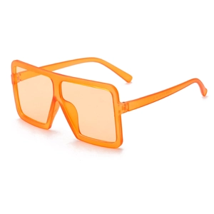 Detail view of oversized square orange sunglasses showing temple interior specs