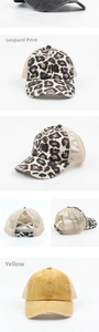 Close-up of distressed ponytail trucker hats with leopard print and mesh panels
