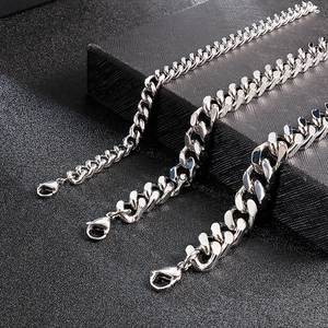 Mens silver stainless steel Cuban link necklaces in three different sizes on black background