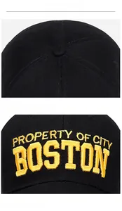 Detail of yellow 3D embroidery on black cotton baseball cap showing fine stitching