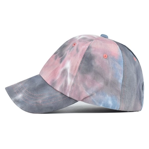 Detailed close-up of a tie-dye cotton visor hat featuring reinforced brim stitching details