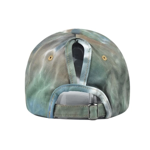 Detail view of tie-dye cotton visor with ponytail hole and adjustable metal buckle