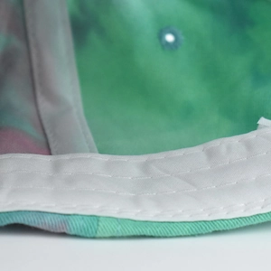 Detail of tie-dye cotton fabric with double-stitched reinforced sweatband construction