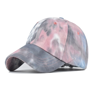 Detailed side view of the tie-dye pattern and stitching on a pink and blue cotton cap