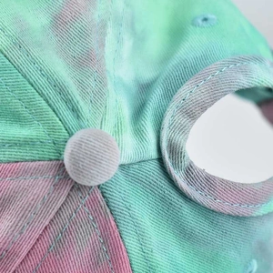 Close-up of tie-dye cotton sun hat showing clean stitching and ponytail hole detail