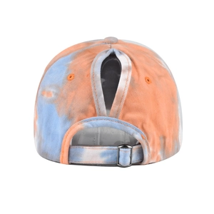 Detail of high ponytail hole and silver metal buckle on tie-dye cotton sun visor hat