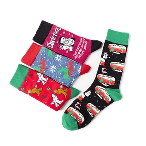 Detailed set of four Christmas socks featuring reindeer and skull patterns on white background