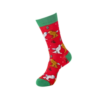Close-up of red and green Christmas socks with cartoon animals and snowflake patterns
