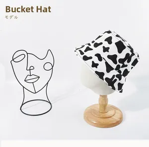 Detail view of stylish cow print bucket hat on a mannequin head for summer sun protection