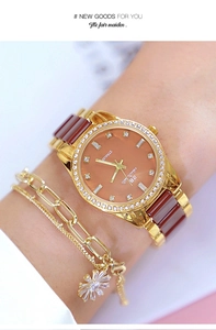 Detail showing gold women's watch with rhinestone bezel and matching floral charm bracelet