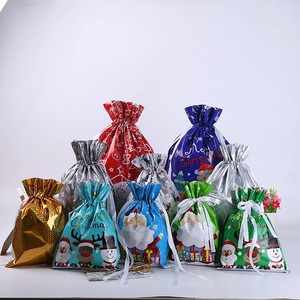 Close-up of assorted foil Christmas drawstring gift bags with colorful festive patterns