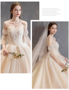 Detail of off-shoulder lace wedding dress with sparkling sequins and intricate embroidery