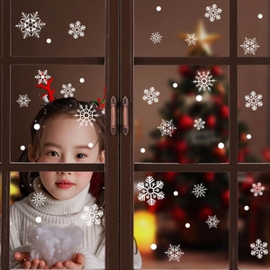 Christmas snowflake window clings on glass with a warm festive holiday background