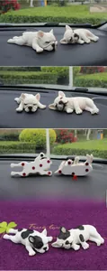 Detailed views of sleeping French Bulldog car ornaments with white and spotted textures