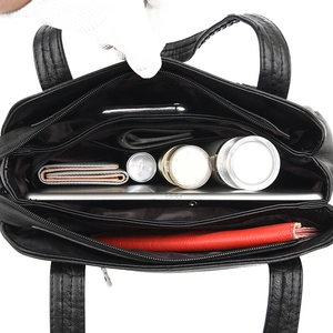 Black leather shoulder bag with spacious multi-compartment interior for daily essentials