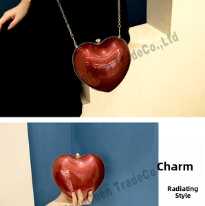 Detail of red heart-shaped evening clutch with glitter texture and gold chain strap