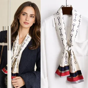Close-up of elegant white silk scarf with retro horsebit pattern and tricolor stripe detail