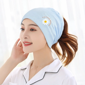 Detail of light blue knit maternity hat featuring Little Daisy embroidery on soft cotton