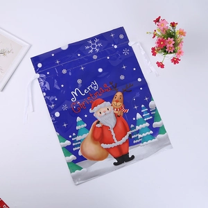 Close-up of blue Merry Christmas drawstring bag with Santa Claus and reindeer graphics