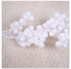 Macro shot of white foam berry clusters for DIY Christmas tree decorations on plush background