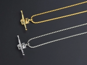Macro shot of punk style titanium steel skateboard truck pendants in gold and silver