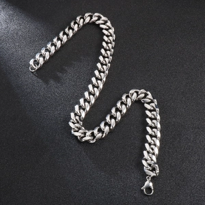 Detailed close-up of a silver stainless steel Cuban link chain with a lobster clasp