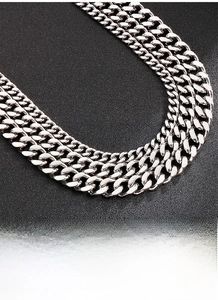Detailed macro view of heavy duty silver curb chain link showing metallic luster and texture