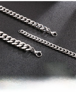 Detailed close-up of polished stainless steel Cuban chains with secure lobster clasps