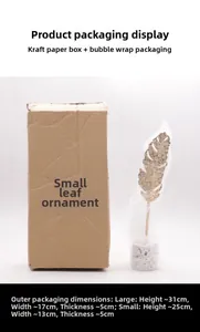 Detail view of gold monstera leaf decor with terrazzo base and protective packaging box