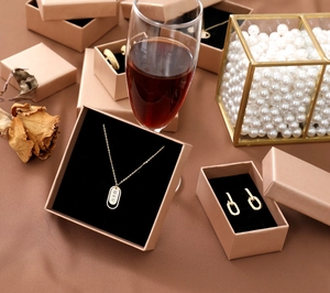 Detail of luxury champagne gold jewelry gift boxes with black velvet lining and accessories